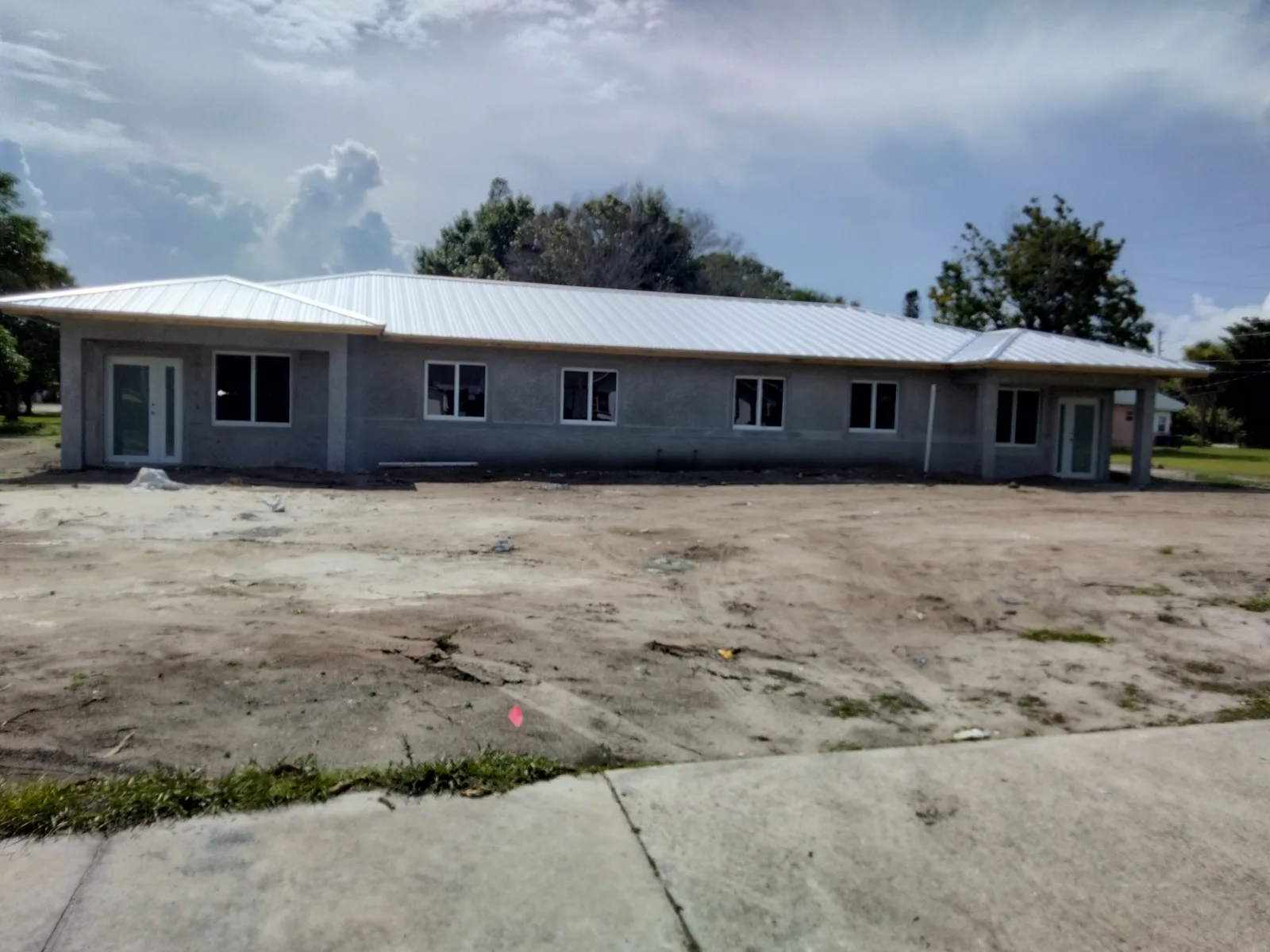 New DND Construction home with roof installed and site work underway
